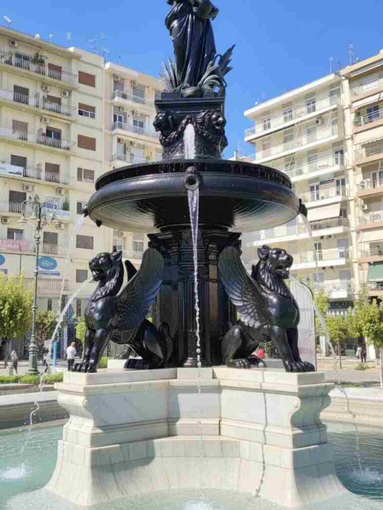 Πάτρα, Patras, Πλατεία Γεωργίου, Georgiou Square, συντριβάνι, fountain, Βασίλης Μαυρομύτης, Vasilis Mavromytis, τεχνητή νοημοσύνη, artificial intelligence, ψηφιακή απεικόνιση, digital rendering, αστική αναβάθμιση, urban renewal, αισθητική πόλης, city aesthetics, καθαρή πλατεία, clean square, Πατραϊκό κέντρο, Patras city center, φωτορεαλιστική εικόνα,